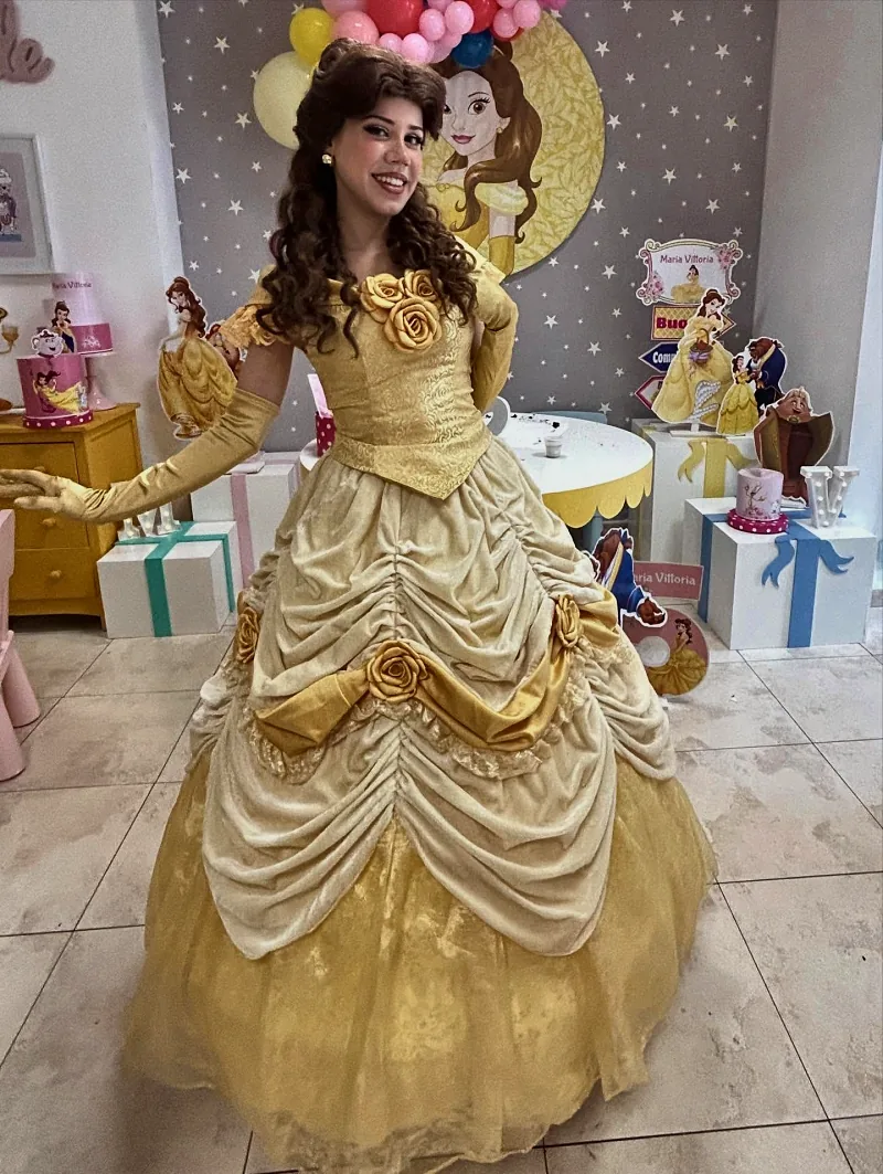 Un'animatrice vestita da principessa in abito giallo, nella sala allestita a tema